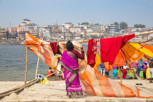 Hanging up washing on banks of Ganges River, Varanasi, Uttar Pradesh, India