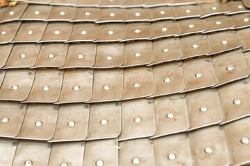 pattern army protective uniform of medieval warrior leather background with iron plates