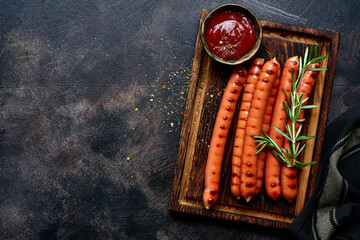 Grilled bavarian sausage with ketchup. Top view with copy space.