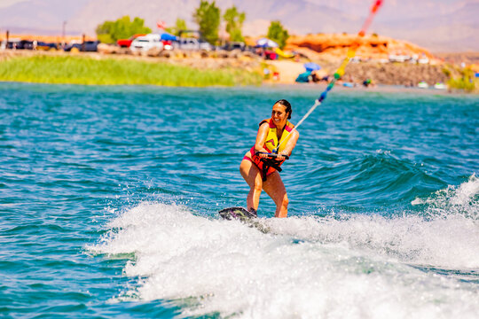 Woman wake boarding at the Sand Hollow Reservoir, Utah, United States of America, North America