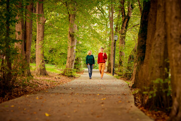 Beautiful woman,blonde,middle-aged,with a big son walking in the Park,a beautiful autumn day