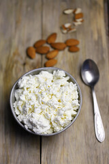 Selective focus. Macro. A bowl of cottage cheese and almonds. Healthy food concept. Diet lunch or breakfast. The keto diet.