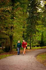 Fototapeta premium Beautiful woman,blonde,middle-aged,with a big son walking in the Park,a beautiful autumn day