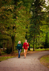 Beautiful woman,blonde,middle-aged,with a big son walking in the Park,a beautiful autumn day