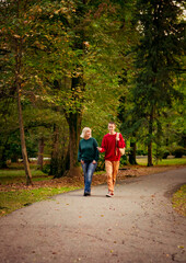 Beautiful woman,blonde,middle-aged,with a big son walking in the Park,a beautiful autumn day