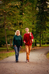 Beautiful woman,blonde,middle-aged,with a big son walking in the Park,a beautiful autumn day