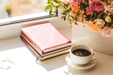 romance and tenderness greeting card concept. mixed flowers bouquet and coffee cup on a window sill composition. copy space. take a brake conceptual