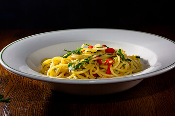 Spaghetti with garlic, olive oil and red hot pepper is on the plate