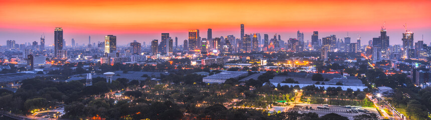 Wide Panoramic View of Bangkok, Thailand. Cityscape with Public Park and Skyscrapers at Twilight.