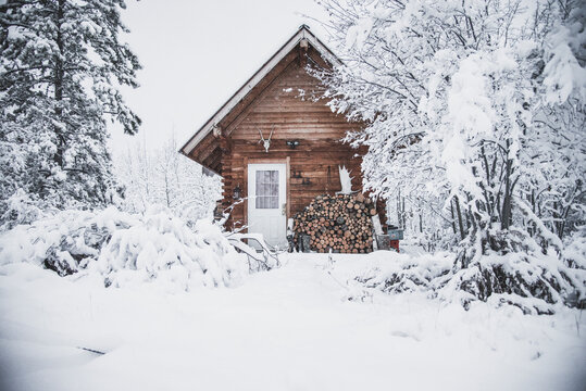 A cozy log cabin in the snowy winter landscape