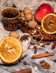 set for cozy autumn. cozy autumn. cup of tea, chocolate cookies, candle, cinnamon, anise, nuts on white knitted sweater. Hygge lifestyle