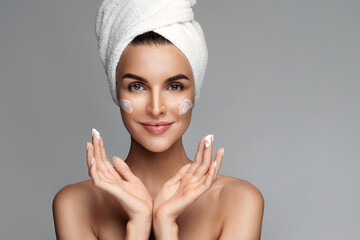 Close up of happy half naked woman applying anti age wrinkle serum, moisturizing lifting nourishing...