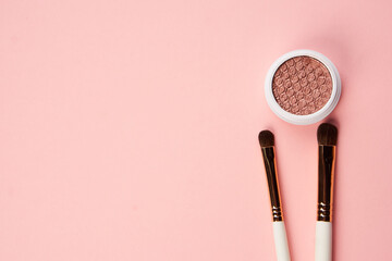 eyeshadow makeup brushes collection professional cosmetics accessories on pink background