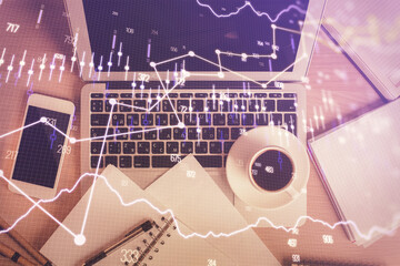 Stock market chart and top view computer on the table background. Double exposure. Concept of financial analysis.