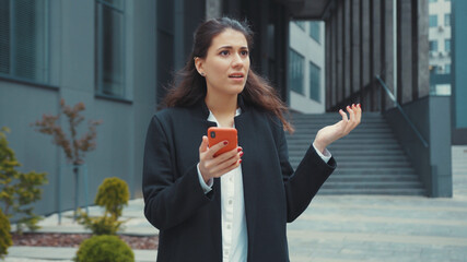 Confused young caucasian woman reading negative news feedback on smartphone frustrating of bad...