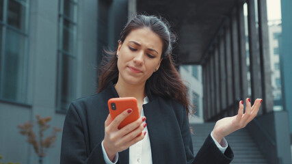 Confused young caucasian woman reading negative news feedback on smartphone frustrating of bad...
