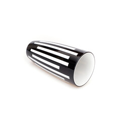 Fallen striped plastic black and white vase isolated on white background