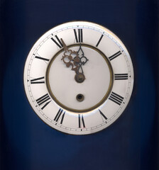 the dial of the vintage mechanical clock on dark background