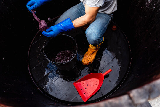 49 years old wine maker working to produce new wine for his winery