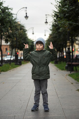 portrait of a five-year-old boy in the city in the fall.
