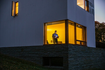 Home office with man Standing in Window