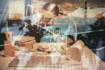 Double exposure of stock market graph drawing and office interior background. Concept of financial analysis.