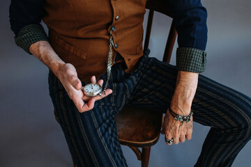 Unrecognizable man checking silver clocks