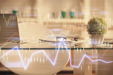 Double exposure of financial graph drawing and office interior background. Concept of stock market.