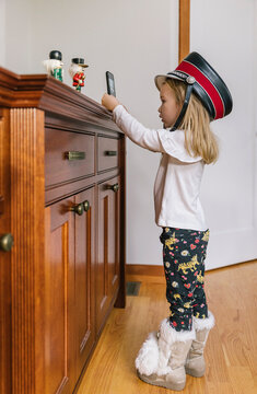 Young Girl with Soldier Hat taking Photos of Nutcracker