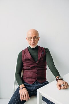 Trendy man sitting near the table