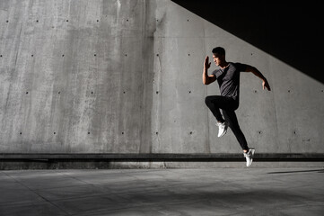 Runner practices his running skills outside with fast pace and goes for run