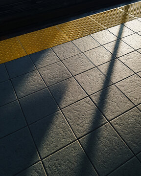 Sunlight and shadow on train platform.