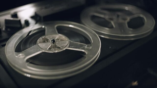 Vintage Tape Recorder Roller. Reel film tape is rotating at a vintage professional player. Oldschool concept