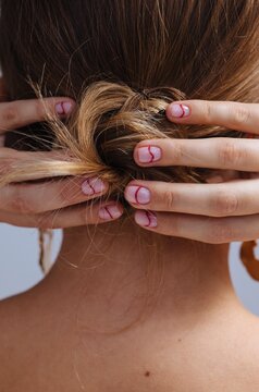 Anonymous woman making hair bun