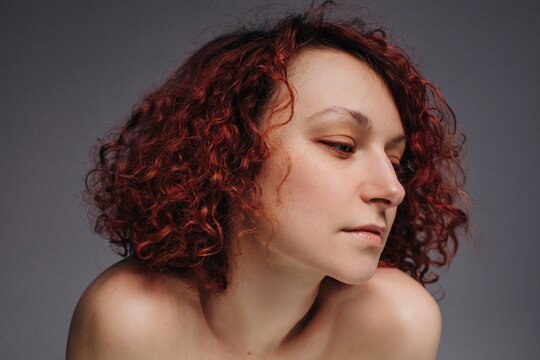 Headshot portrait of amazing curly woman with red hair