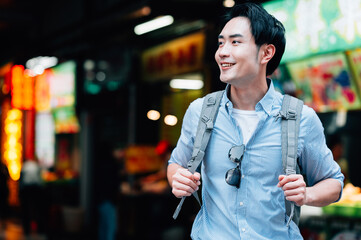 Young asian man traveling in a city downtown