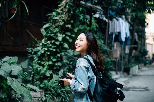 Young Asian Woman Traveling In A City