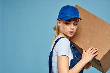 Woman working form box in hands packing delivery service blue background