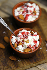 Selective focus. Macro. A bowl of cottage cheese with topping and almonds. Healthy food concept. Diet lunch or breakfast. The keto diet.