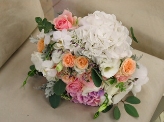 Close up of wedding bouquet on a beige chair