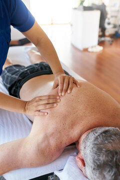 Patient receiving a massage treatment of his back
