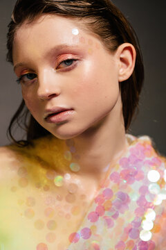 Sensual young relaxed woman with glitter makeup