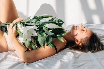 blond woman with bouquet of lilies
