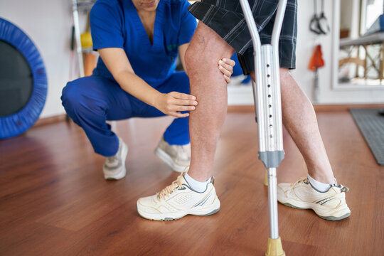 Physiotherapist working on patient's knee