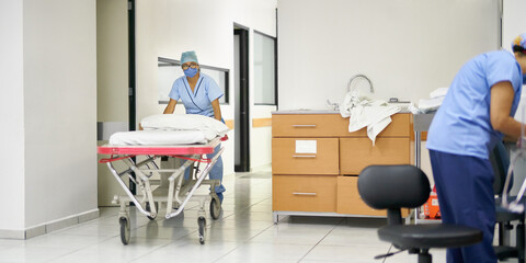 Nurse preparing a movable bed in a hospital