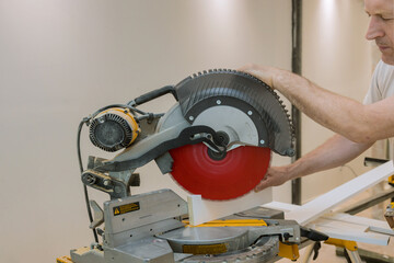 Construction details of carpenter using circular saw for cutting wooden boards
