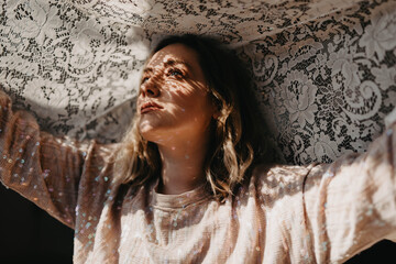 A young blonde woman in her twenties on a rooftop at sunset