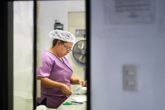Sterilization Technician preparing tools for surgery