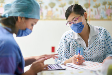 Doctor and nurse preparing documents with a tablet