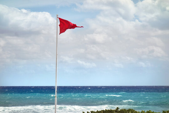 Red warning flag at the shore